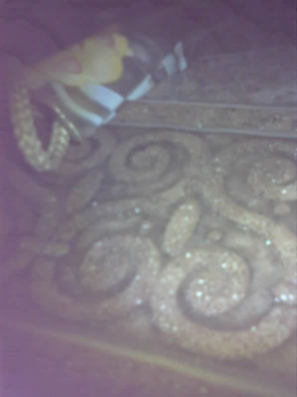 Saved camera frame: spiral carvings worked into a rock face.