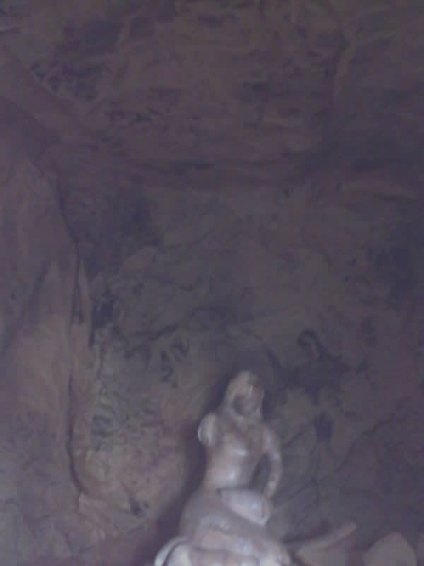 Saved camera frame: a dark corner of the chamber running back past the light.
